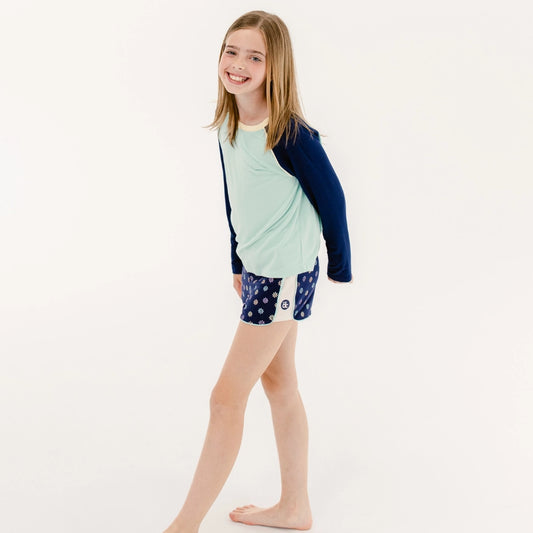 model wearing decidedly unique long sleeve sleep top with dreamscape sleep short, the decided collection, pajamas and loungewear for tween girls