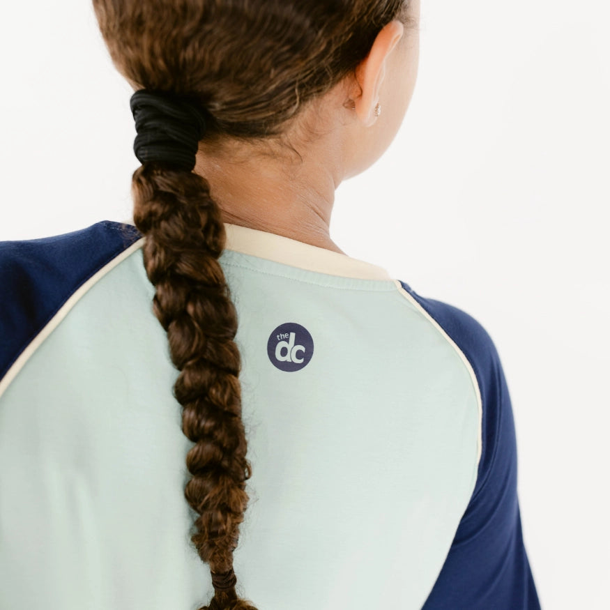 back logo detailing of decidedly unique long sleeve sleep top, the decided collection, pajamas and loungewear for tween girls